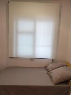 a small bedroom with a bed with a window at Arco Centro Cádiz in Cádiz
