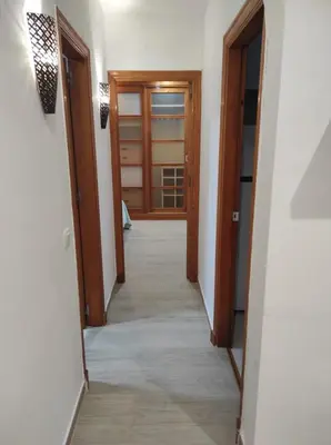a hallway with two wooden doors and a hallwayngth at Arco Centro Cádiz in Cádiz