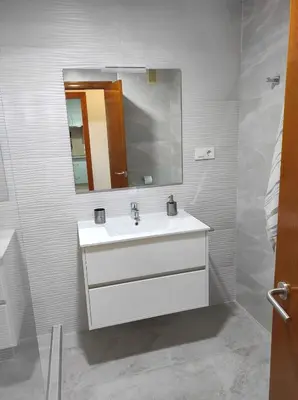 a bathroom with a white sink and a mirror at Arco Centro Cádiz in Cádiz