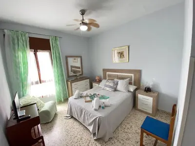 a bedroom with a bed with two stuffed animals on it at Apartamento Acuario in Sanlúcar de Barrameda