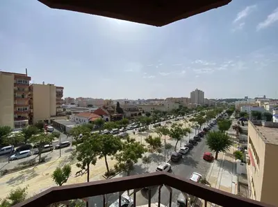 a view from a balcony of a city street with cars at Apartamento Acuario in Sanlúcar de Barrameda