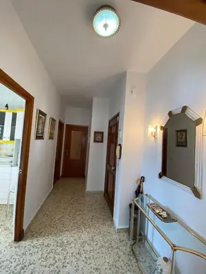 a room with a hallway with a mirror on the wall at Apartamento Acuario in Sanlúcar de Barrameda