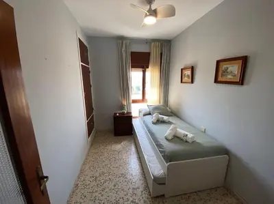 a bedroom with a bed with two stuffed animals on it at Apartamento Acuario in Sanlúcar de Barrameda