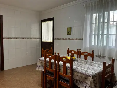 a room with a table and chairs and a window at Casa Campiña Jerezana in Torrecera