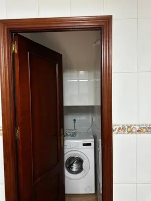 a door open to a laundry room with a washing machine at Casa Campiña Jerezana in Torrecera