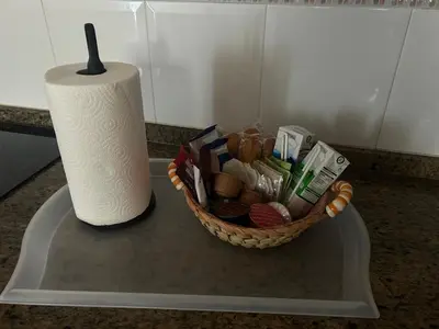 a basket on a counter next to a roll of toilet paper at Casa Campiña Jerezana in Torrecera