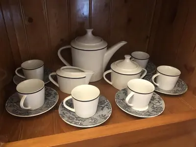a group of cups and saucers on a wooden shelf at Casa Campiña Jerezana in Torrecera