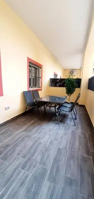 a room with a table and chairs in a room at Apartamento Plaza Calzada 1 in Sanlúcar de Barrameda