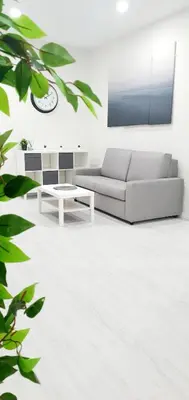 a living room with a couch and a table at Apartamento Plaza Calzada 1 in Sanlúcar de Barrameda
