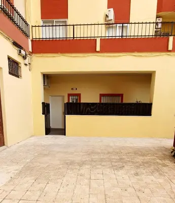 an empty courtyard of a building with a balcony at Apartamento Plaza Calzada 1 in Sanlúcar de Barrameda
