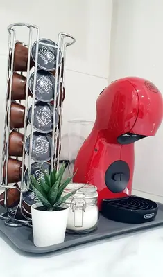 a red mixer sitting on a tray with a plant at Apartamento Plaza Calzada 1 in Sanlúcar de Barrameda