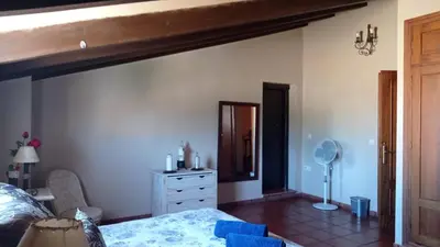a bedroom with a bed and a dresser and a mirror at El Amanecer in El Puerto de Santa María