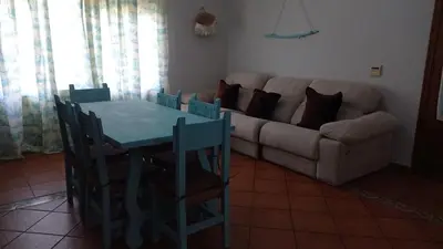 a living room with a table and a couch at El Amanecer in El Puerto de Santa María