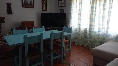 a living room with a blue table and chairs at El Amanecer in El Puerto de Santa María