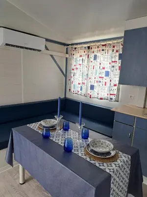 a table with two plates and blue glasses on it at Apartamento el ronco. in Conil de la Frontera