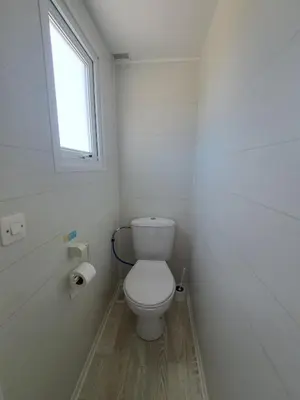 a small bathroom with a toilet and a window at Apartamento el ronco. in Conil de la Frontera