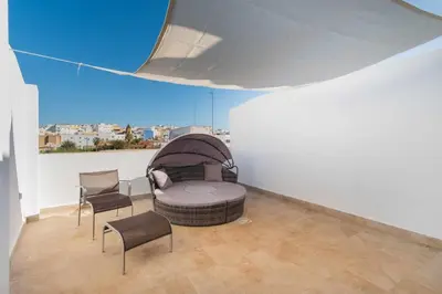 a room with a dog bed and two chairs in it at Jacuzzi Amanecer de Plata Decoración Romántica in Chiclana de la Frontera