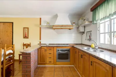 a kitchen with a sink and a stove at CHALET ROBLES in Cádiz