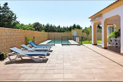 two blue lounge chairs sitting on a patio at CHALET ROBLES in Cádiz