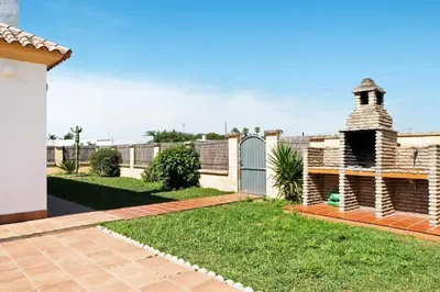 a backyard with a fence and a gate at CHALET ROBLES in Cádiz