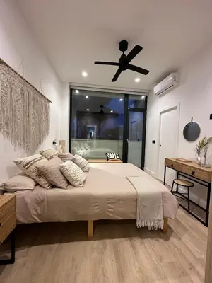 a bedroom with a bed and a ceiling fan at VILLA SARAH Barrosa Playa in Chiclana de la Frontera
