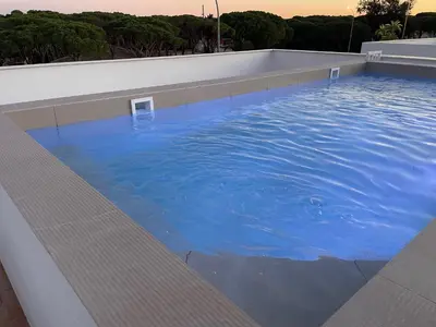 a large pool of blue water on a building at VILLA SARAH Barrosa Playa in Chiclana de la Frontera