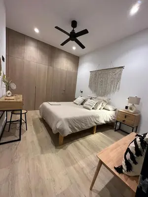 a bedroom with a bed and a ceiling fan at VILLA SARAH Barrosa Playa in Chiclana de la Frontera