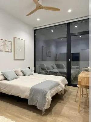 a bedroom with a large bed with a ceiling at VILLA SARAH Barrosa Playa in Chiclana de la Frontera