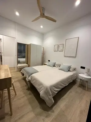 a bedroom with a large bed with a ceiling at VILLA SARAH Barrosa Playa in Chiclana de la Frontera