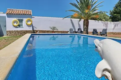 a swimming pool in front of a villa at Chalet Cielo Azul in Conil de la Frontera