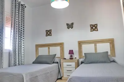 two beds sitting next to each other in a bedroom at Chalet Cielo Azul in Conil de la Frontera