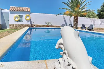 a swimming pool in front of a villa at Chalet Cielo Azul in Conil de la Frontera