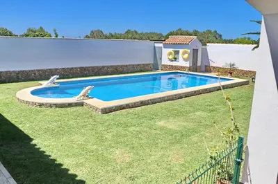 a swimming pool in a yard with a house at Chalet Cielo Azul in Conil de la Frontera