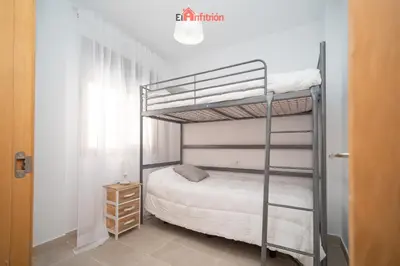 a bedroom with a bunk bed in a room at Banda Playa - Arizón in Sanlúcar de Barrameda