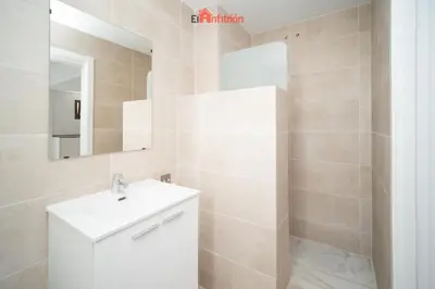 a bathroom with a white sink and a mirror at Banda Playa - Arizón in Sanlúcar de Barrameda