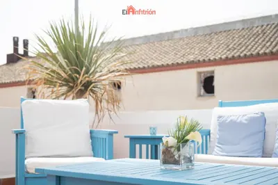 a blue table and two chairs on a patio at Banda Playa - Arizón in Sanlúcar de Barrameda