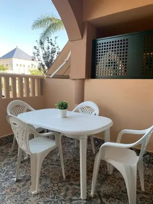 a white table and chairs on a balcony at Apartamento Al Andalus. La Barrosa. in Chiclana de la Frontera