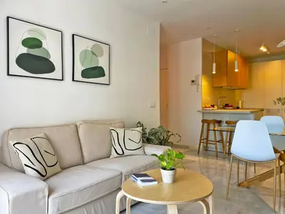 a living room with a couch and a table at Apartamento El Carmen - Ole Solutions in Jerez de la Frontera
