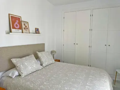 a bedroom with a bed with white cabinets at Apartamento El Carmen - Ole Solutions in Jerez de la Frontera