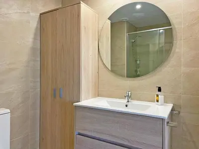 a bathroom with a sink and a mirror at Apartamento El Carmen - Ole Solutions in Jerez de la Frontera