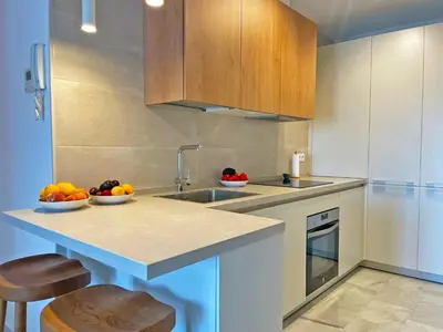 a kitchen with a sink and a counter with fruit on it at Apartamento El Carmen - Ole Solutions in Jerez de la Frontera