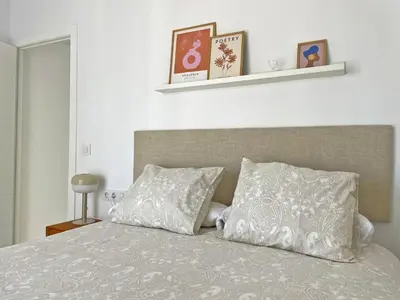a bedroom with a bed with two pillows on it at Apartamento El Carmen - Ole Solutions in Jerez de la Frontera