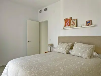 a bedroom with a large bed with two pillows at Apartamento El Carmen - Ole Solutions in Jerez de la Frontera