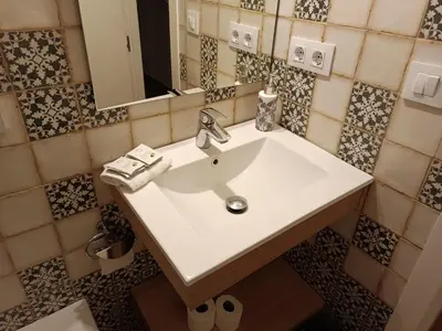 a bathroom with a white sink and a mirror at Apartamento interior en Rosario in Cádiz