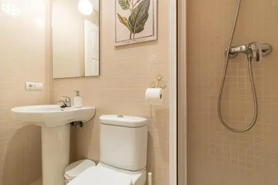 a bathroom with a toilet and a sink and a shower at Allo Apartments Santo Domingo Parking 2 Habitaciones in Jerez de la Frontera