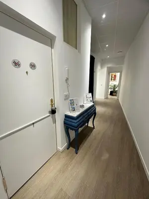 a hallway of an office with a door and a bench at Apartamento Nebro Luna, En el Corazón de Cádiz in Cádiz