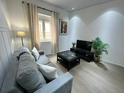 a living room with a couch and a table at Apartamento Nebro Luna, En el Corazón de Cádiz in Cádiz