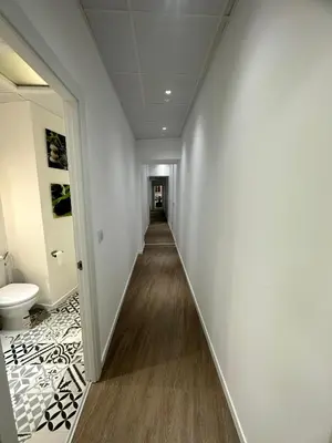 a hallway with white walls and a toilet in a room at Apartamento Nebro Luna, En el Corazón de Cádiz in Cádiz
