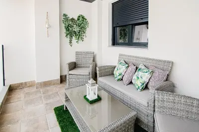 a living room with a couch and two chairs at Nautilus 3 - Elegante Apartamento para 6 con Piscina, Wifi y AC en Rota in Rota