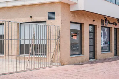 a brick building with a fence in front of it at Nautilus 3 - Elegante Apartamento para 6 con Piscina, Wifi y AC en Rota in Rota